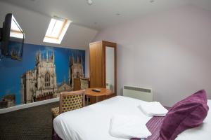 a bedroom with a bed and a table in it at Georgian House & Mews in York