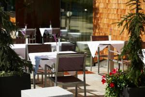 a group of tables and chairs with plants and flowers at Sternen Hotel Wolfurt in Bregenz