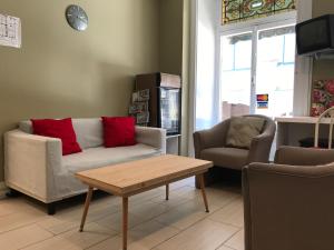 a living room with a couch and two chairs and a table at Auberge St-Louis in Quebec City