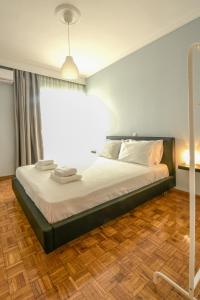 duże łóżko w pokoju z dużym oknem w obiekcie Seaside Flat w mieście Kawala