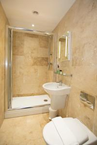 a bathroom with a toilet and a sink and a tub at Georgian House & Mews in York