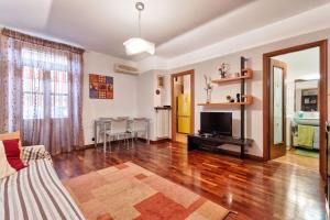 ein Wohnzimmer mit einem Sofa und einem TV in der Unterkunft Crocetta&Politecnico Huge Apartment in Turin