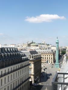 a view of a city with a clock tower at Le Meurice – Dorchester Collection in Paris