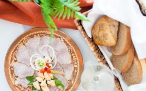 a table topped with a plate of food with bread at Hotel Park Superior 3* in Čakovec