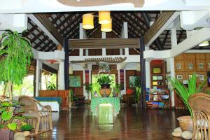 a lobby with chairs and plants in a building at Tadlo Lodge in Salavan