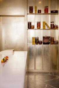 a kitchen with a counter and shelves of food at Le Meurice – Dorchester Collection in Paris