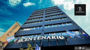 a tall blue building with a sign on it at Hotel Bicentenario Suites & Spa in San Miguel de Tucumán