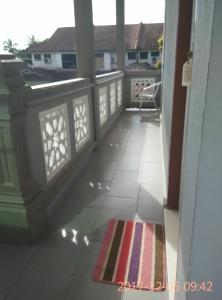 a view of a balcony with a rug at Penginapan MyCJ - Roomstay in Kuala Terengganu