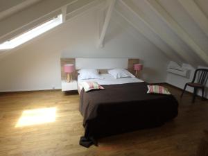 a bedroom with a large bed in a attic at Cap Est in Le Moule