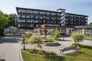 un bâtiment avec un banc devant lui dans l'établissement Johannesbad Hotel Königshof, à Bad Füssing