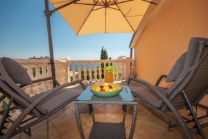 a table with a bowl of fruit on a patio at Apartment Anai Rijeka in Rijeka