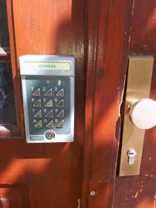 a remote control is attached to a wooden door at Tabor - Apartments Rozmanova Street in Ljubljana