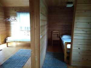 a room with two beds in a log cabin at Suomela Camping in Kärsämäki