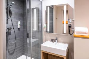 a bathroom with a sink and a shower at ibis Styles Clamart Gare Grand Paris in Clamart +63 photos