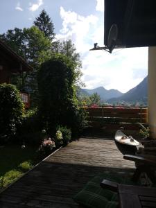 a wooden walkway with a view of the mountains at Bed and Breakfast Lucia in Pfronten