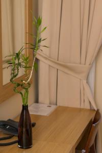 a vase with plants in it sitting on a table at Hotel Lirak in Tetovo