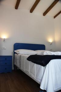 a bed with a blue headboard in a room at Levantara in Jezera