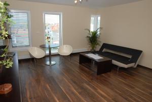 a living room with a couch and a table at Hotel Helada in Mladá Boleslav