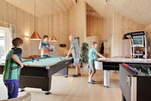 a group of people playing pool in a room at Luksus-poolhus B5 in Harboør