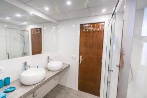 a bathroom with a sink and a mirror at Las Gondolas Seaview in La Manga del Mar Menor +30 photos