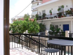 a balcony with a table and chairs on a building at Eleni Apartments in Preveza