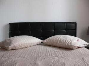 two pillows sitting on top of a bed at Eleni Apartments in Preveza