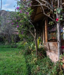 a house with flowers on the side of it at Eco Lodge Los Perales-Urubamba in Urubamba