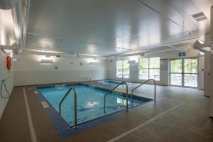 a large swimming pool in a large building at Coast Oliver Hotel in Oliver