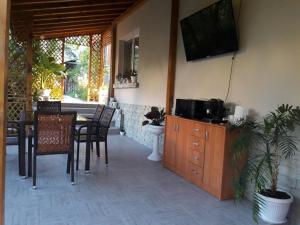 a living room with a television and a table and chairs at Georgievi Guest House in Sapareva Banya