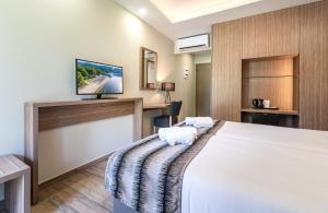 Postel nebo postele na pokoji v ubytování Poseidon Hotel Sea Resort