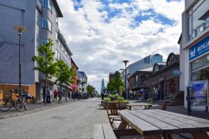 a street with tables and benches in a city at GreenKey Apartment SK2 in Reykjavík