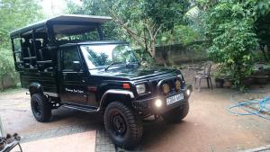 a black jeep parked in a yard at Kottamba Yala Stay & Safari in Tissamaharama