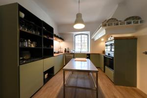 a kitchen with green cabinets and a wooden table at Quinta da Fogueira in Anadia