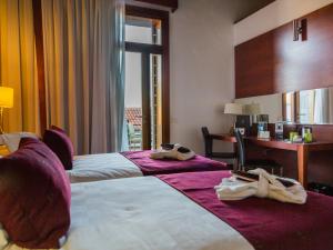 A bed or beds in a room at La Casona del Patio