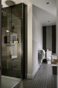 a bathroom with a glass shower and a toilet at The Old Bank Town House in Kinsale