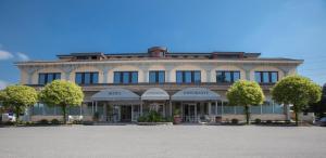 a large building with trees in front of it at Hotel Ristorante Continental in Osio Sotto