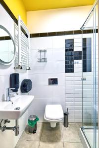 a bathroom with a sink and a toilet and a shower at Draggo House - Premium Rooms - Old Town in Krakow +34 photos