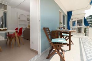 a living room with a table and chairs on a balcony at Oporto in Benicàssim