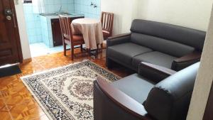 a living room with a couch and a table at Hostal Santa María Gracia in Quito