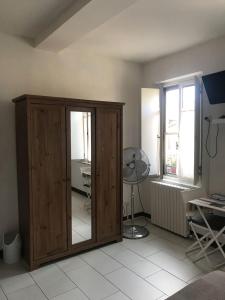 a room with a wooden cabinet and a window at Mavi's bedrooms in Lucca