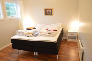 uma cama com cobertores e almofadas num quarto em Apartment 2, Herand, Hardanger em Herand