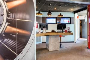 two pictures of an office with a counter and a desk at ibis Salon de Provence in Salon-de-Provence
