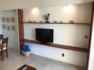 a living room with a flat screen tv on a wall at Departamento 523 con playa dentro de Hotel en Ixtapa in Ixtapa