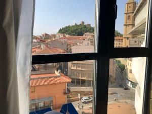 a view of a city from a window at Apartamentos Los Angeles in Alcañiz