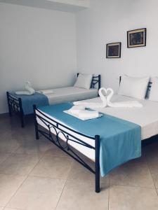 two beds sitting next to each other in a room at Vila Kosteli in Himare