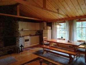 a kitchen with a wooden table in a room at Villa Karhunkehto in Luosto
