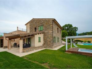 a stone house with a pool and a yard at Serre Alte Landscape Luxury Rooms in Matelica