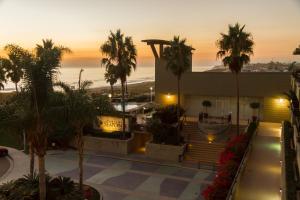 a view of a building with palm trees and the ocean at Carlsbad Seapointe Resort in Carlsbad