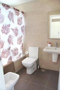 a bathroom with a toilet and a sink at Ciencias Forum Apartment by A3Rentals in Granada