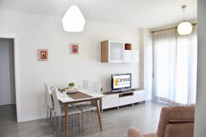 uma sala de estar com uma mesa de jantar e uma televisão em Ciencias Forum Apartment by A3Rentals em Granada